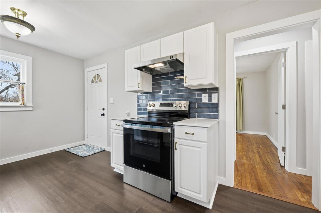 702 North Church Street Decatur, TX 76234 - Photo 27 of 36 a kitchen with stainless steel appliances granite countertop a stove and a refrigerator