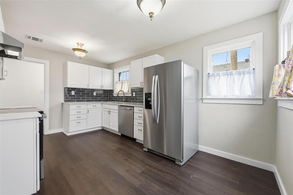 702 North Church Street Decatur, TX 76234 - Photo 30 of 36 a kitchen with stainless steel appliances a refrigerator sink and cabinets