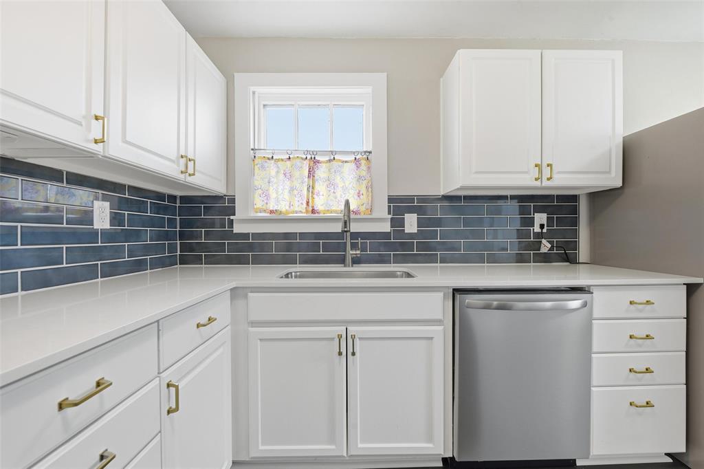 702 North Church Street Decatur, TX 76234 - Photo 31 of 36 a kitchen with white cabinets and sink