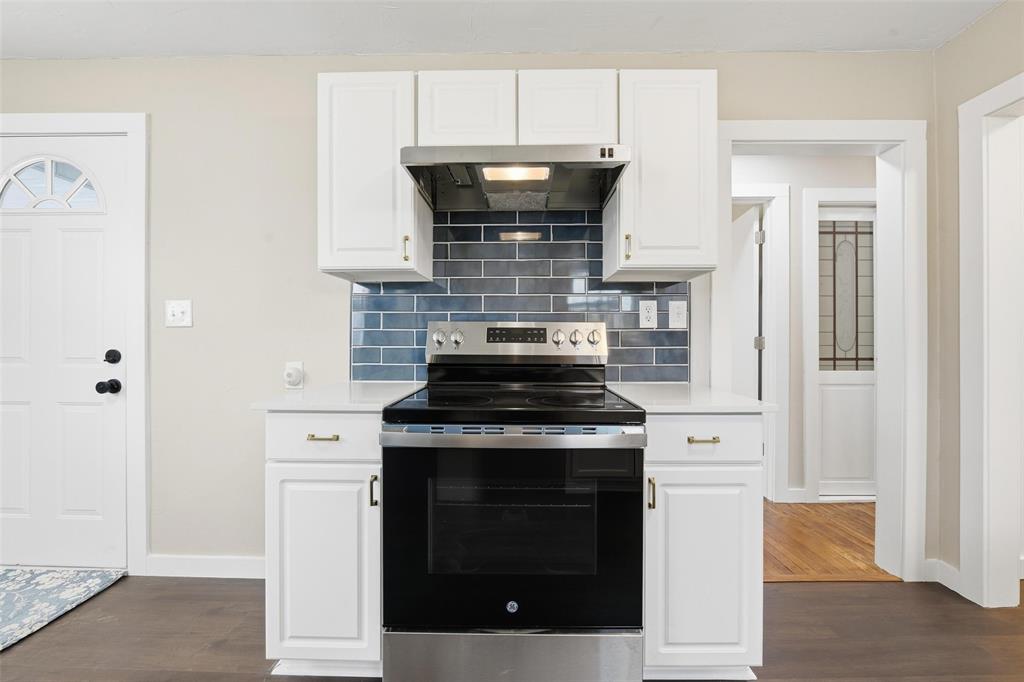 702 North Church Street Decatur, TX 76234 - Photo 32 of 36 a stove top oven sitting inside of a kitchen