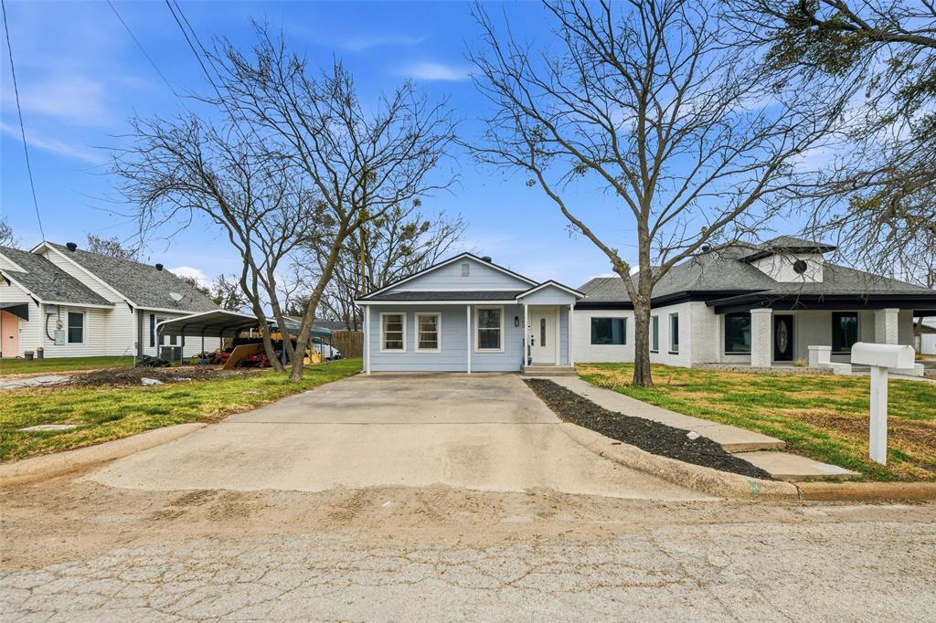 702 North Church Street Decatur, TX 76234 - Photo 4 of 36 a front view of a house with a yard