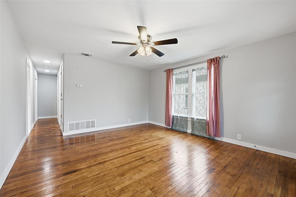 702 North Church Street Decatur, TX 76234 - Photo 6 of 36 a view of an empty room with window and wooden floor