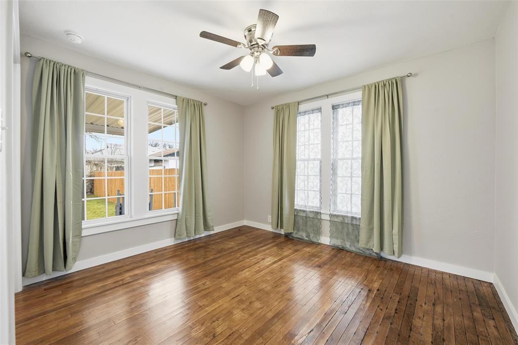 702 North Church Street Decatur, TX 76234 - Photo 10 of 36 a view of an empty room with a window and wooden floor