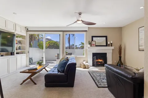 a living room with furniture fireplace and flat screen tv