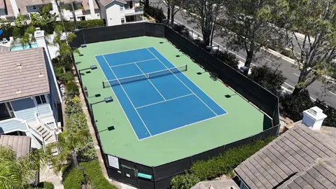 an aerial view of a house a yard swimming pool and outdoor seating