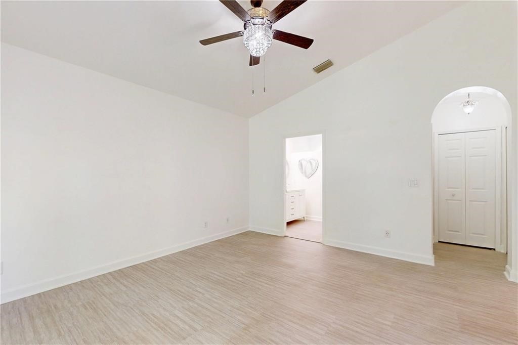 115 Briarcliff Circle Sebastian, FL 32958 - Photo 14 of 26 an empty room with a ceiling fan and wooden floor
