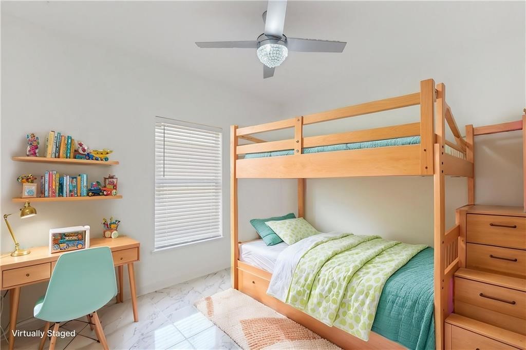 115 Briarcliff Circle Sebastian, FL 32958 - Photo 21 of 26 a bedroom with a bed and a chair