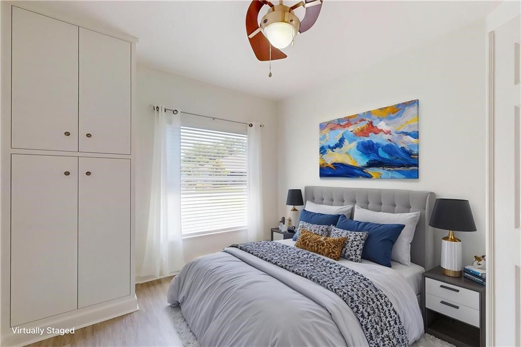 115 Briarcliff Circle Sebastian, FL 32958 - Photo 23 of 26 a bedroom with a bed and a painting on the wall