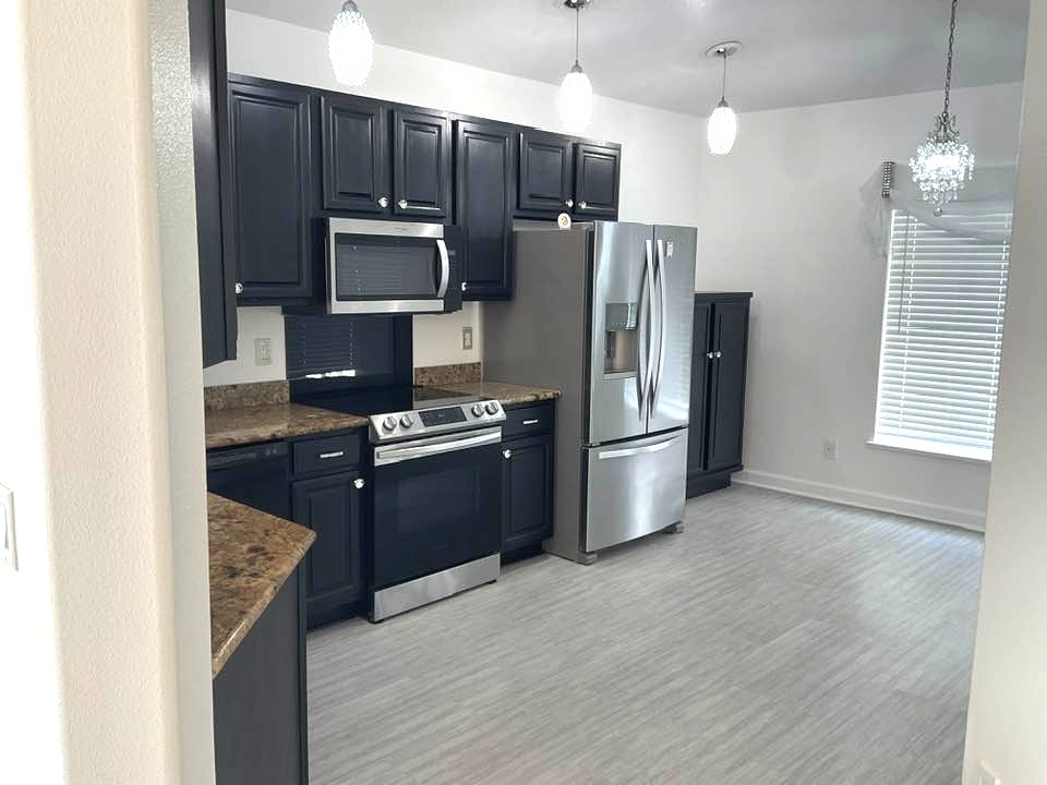 115 Briarcliff Circle Sebastian, FL 32958 - Photo 5 of 26 a kitchen with stainless steel appliances a refrigerator stove and microwave