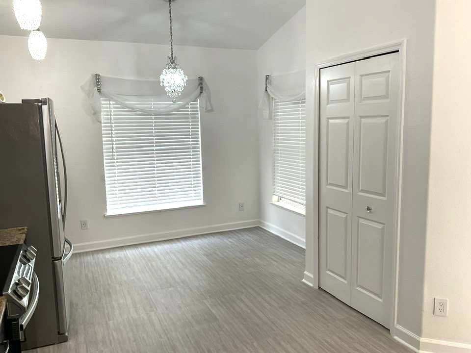 115 Briarcliff Circle Sebastian, FL 32958 - Photo 6 of 26 a view of an empty room with wooden floor and a window