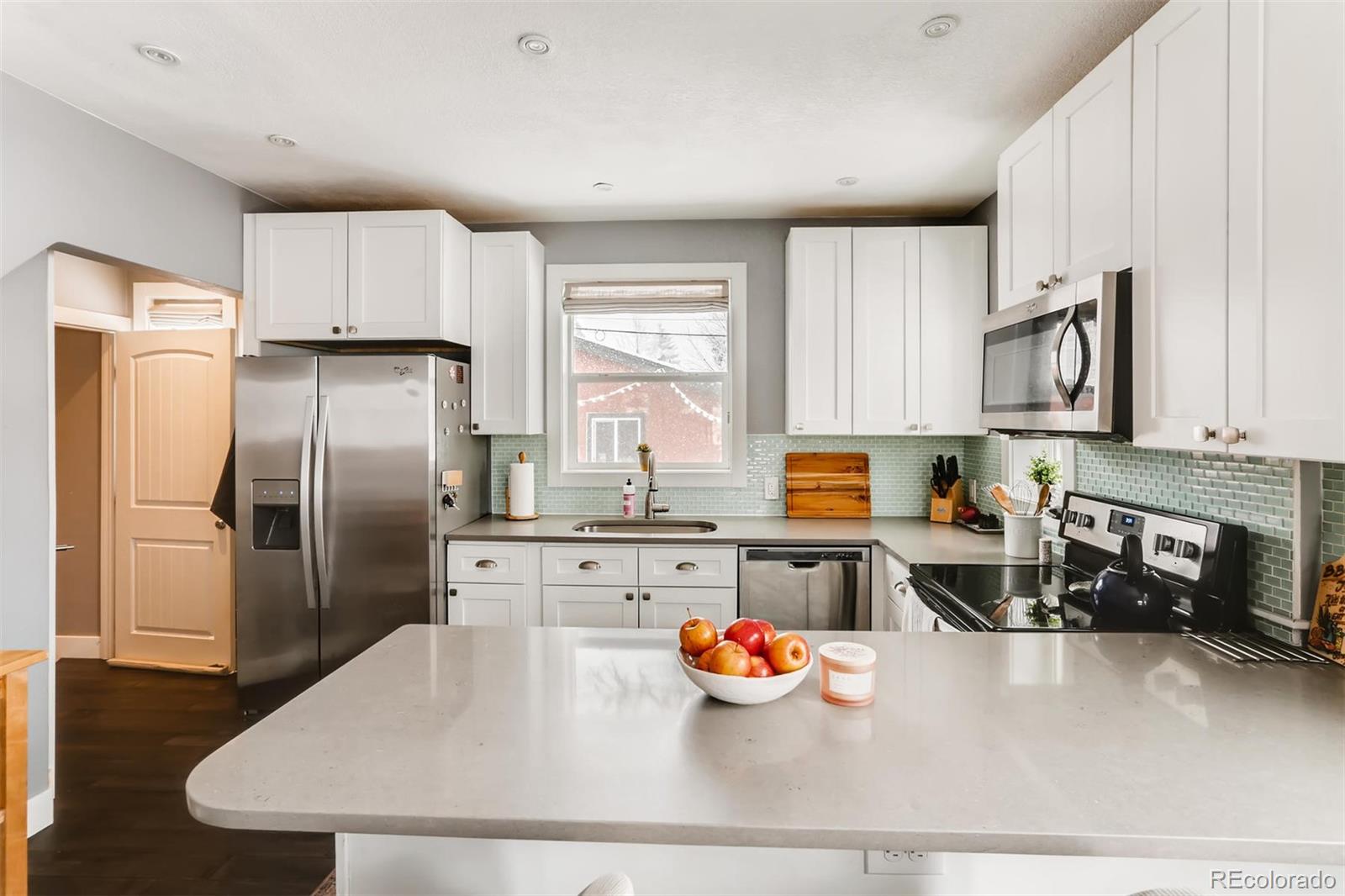 3510 Elizabeth Street Denver, CO 80205 - Photo 13 of 39 a kitchen with a refrigerator and a stove top oven