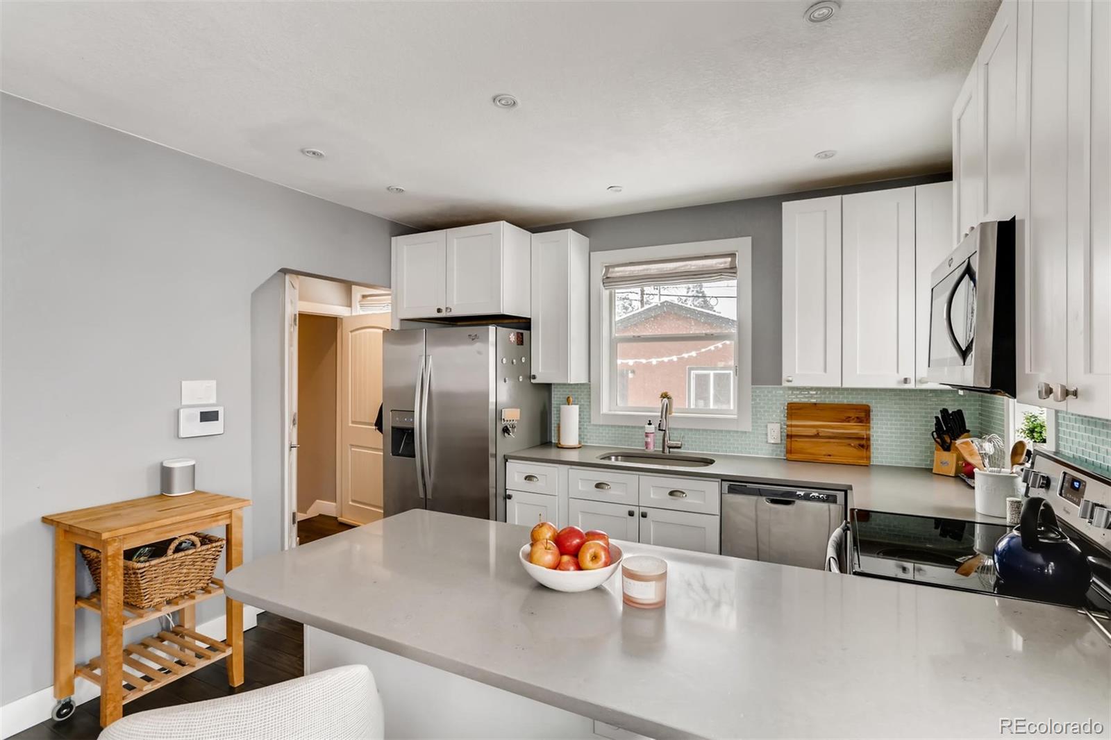 3510 Elizabeth Street Denver, CO 80205 - Photo 14 of 39 a kitchen with stainless steel appliances granite countertop a sink stove and refrigerator