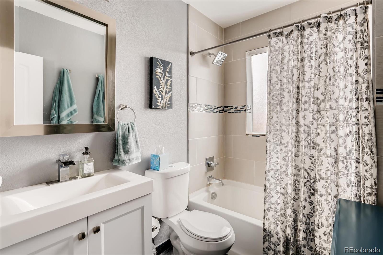 3510 Elizabeth Street Denver, CO 80205 - Photo 19 of 39 a bathroom with a sink a toilet and shower