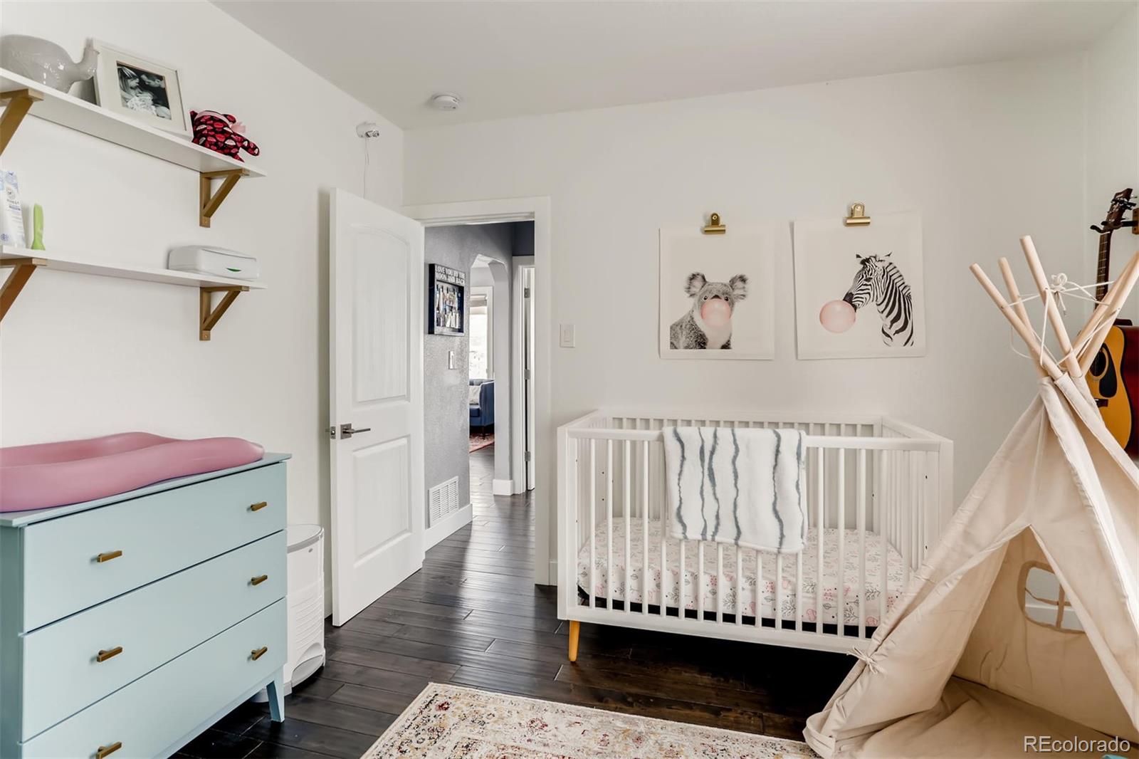 3510 Elizabeth Street Denver, CO 80205 - Photo 21 of 39 a bedroom with furniture and wooden floor