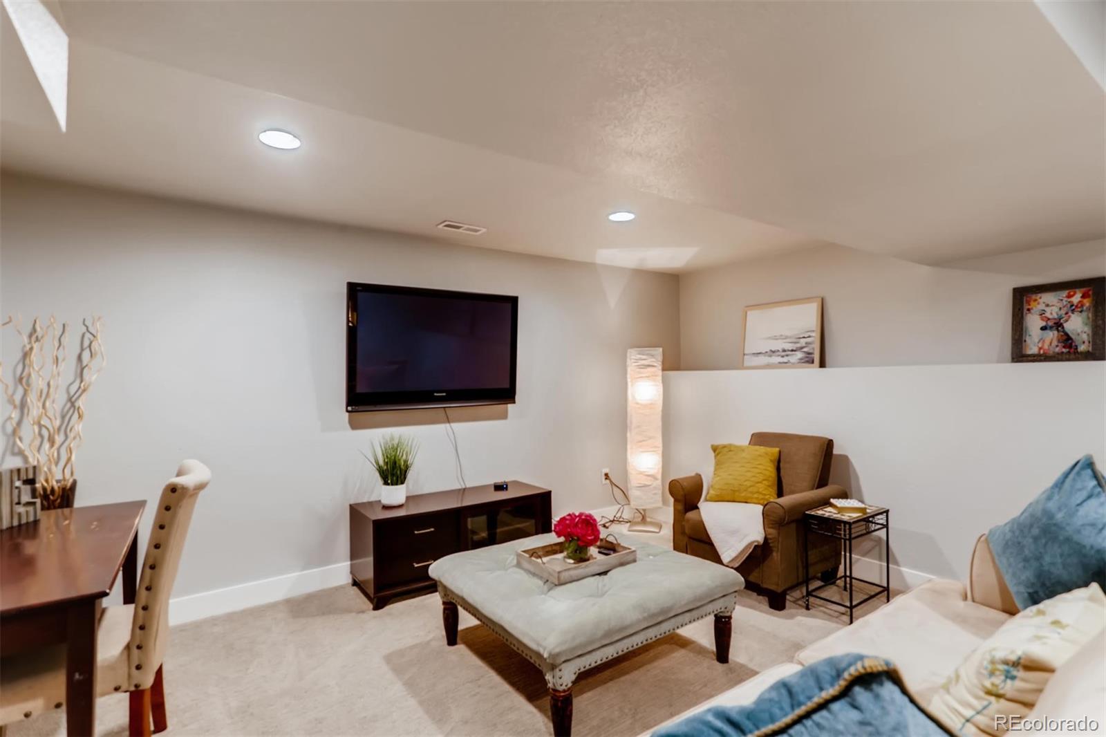 3510 Elizabeth Street Denver, CO 80205 - Photo 23 of 39 a living room with furniture and a flat screen tv