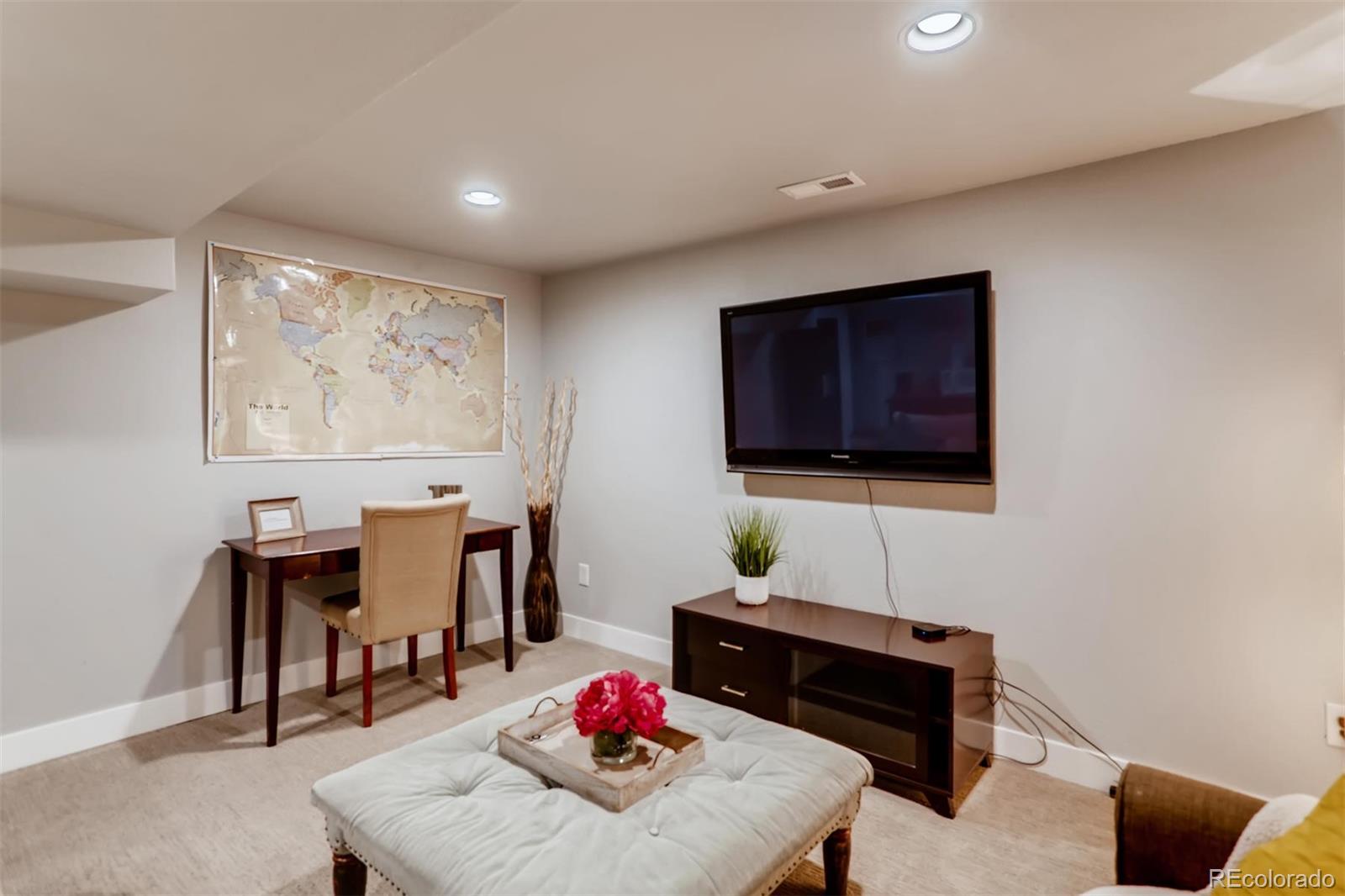 3510 Elizabeth Street Denver, CO 80205 - Photo 25 of 39 a living room with furniture and a flat screen tv