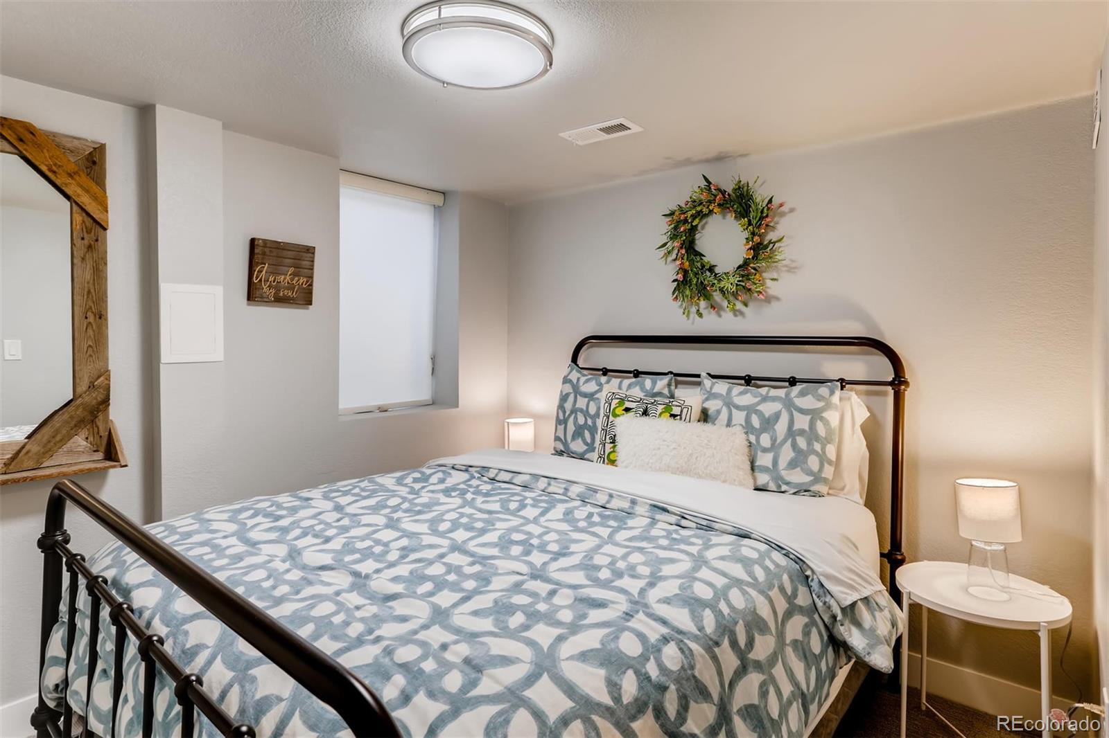 3510 Elizabeth Street Denver, CO 80205 - Photo 26 of 39 a bedroom with a bed and a lamp