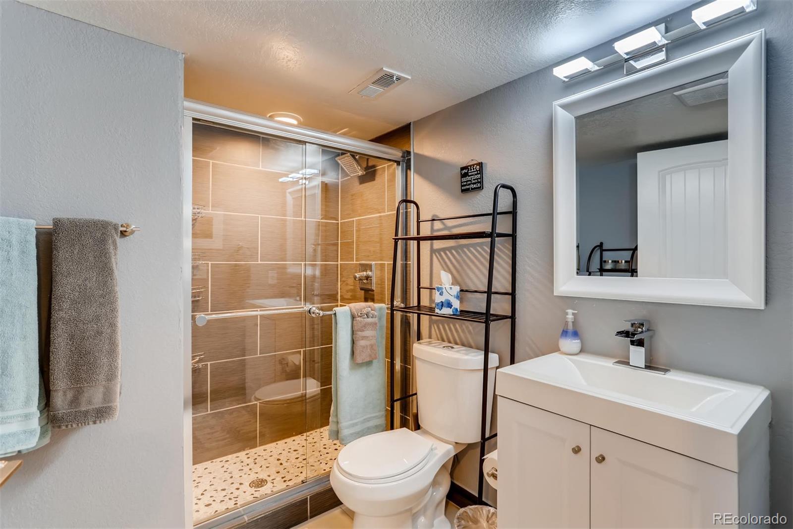 3510 Elizabeth Street Denver, CO 80205 - Photo 27 of 39 a bathroom with a sink toilet and shower