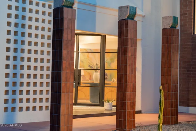 a view of a swimming pool with outdoor seating and plants
