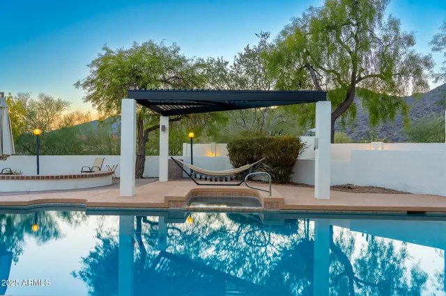 a view of a building with a yard and sitting area