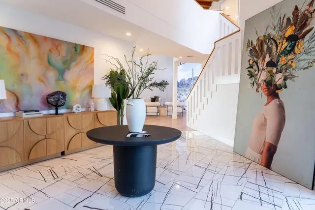 a living room with furniture and a painting on the wall
