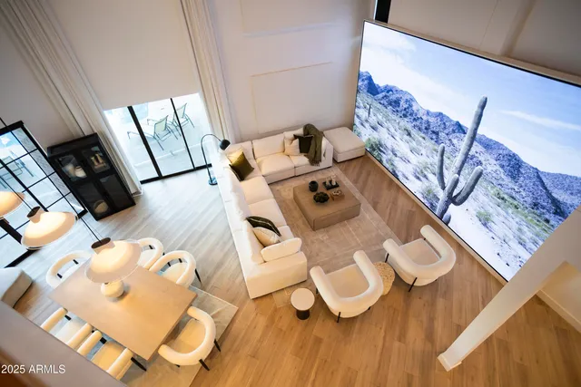 a living room with furniture and a chandelier