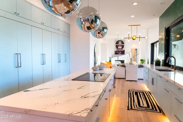 a living room with furniture a rug and a chandelier