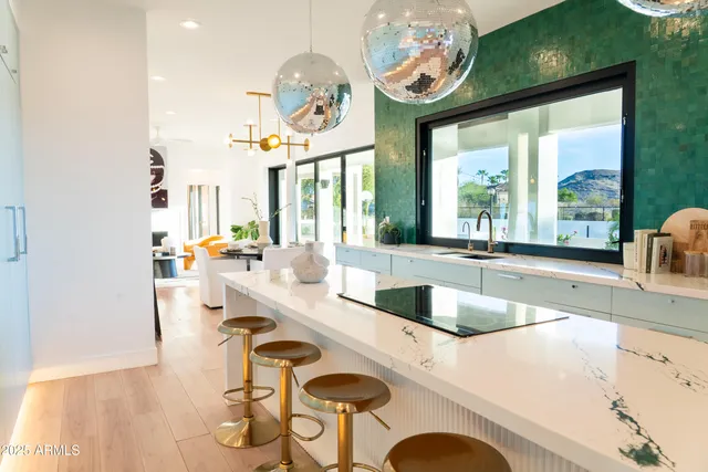 a living room with fireplace furniture and a large window