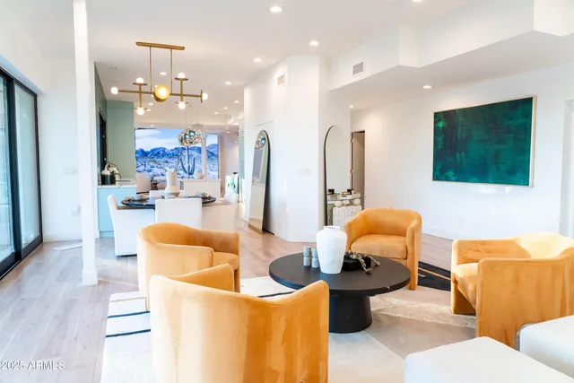 a room with furniture a rug and a chandelier