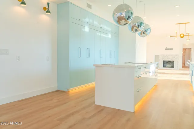 a view of a kitchen with wooden floor and a chandelier