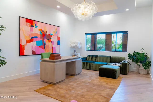 a bedroom with a bed lamp and a large window