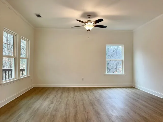 wooden floor in an empty room with a window