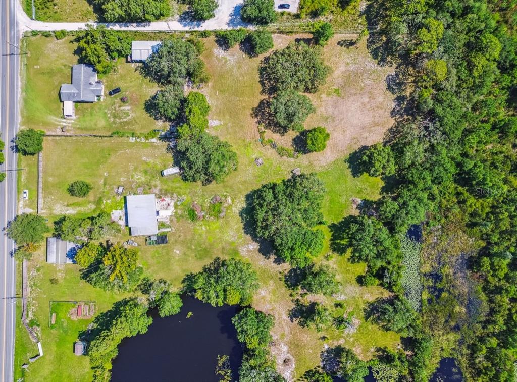12321 Shady Hills Road Spring Hill, FL 34610 - Photo 30 of 30 a view of a lake with a building in the background