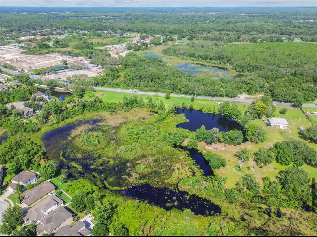 12321 Shady Hills Road Spring Hill, FL 34610 - Photo 4 of 30 an aerial view of residential houses with outdoor space and trees
