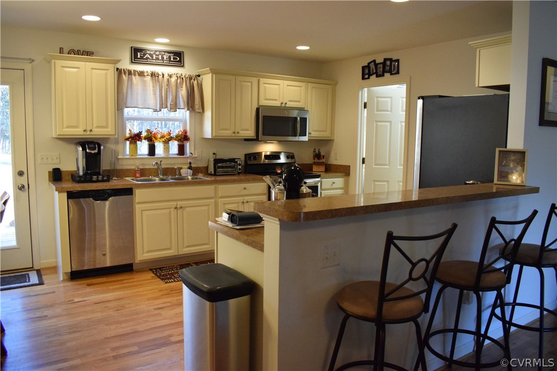 5185 Broad St Road Louisa, VA 23093 - Photo 6 of 24 a kitchen with stainless steel appliances a stove a sink refrigerator and a microwave