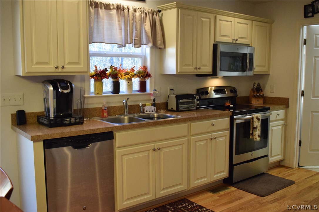 5185 Broad St Road Louisa, VA 23093 - Photo 8 of 24 a kitchen with stainless steel appliances granite countertop a stove a sink and a microwave