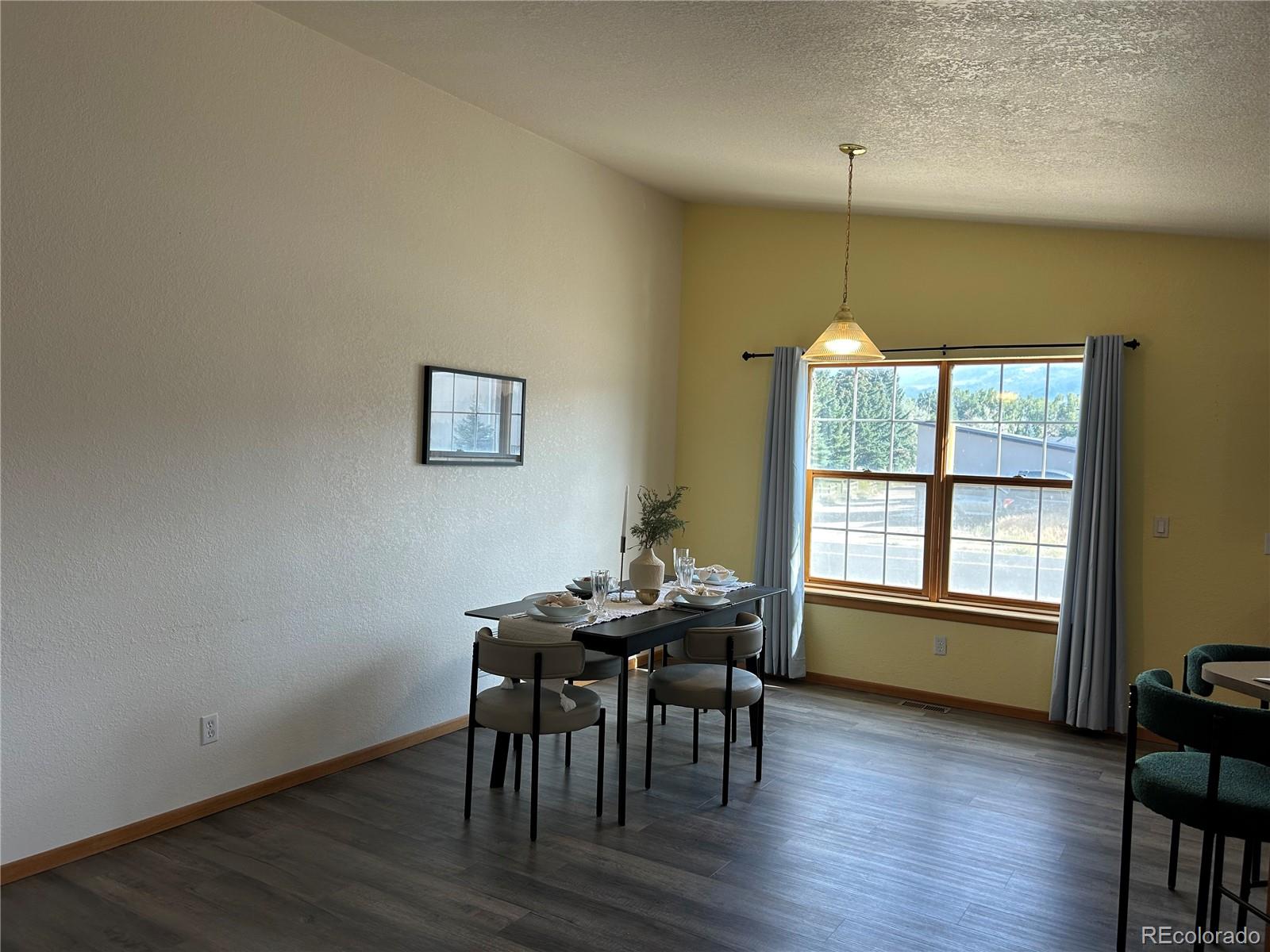 7401 County Road 141 Salida, CO 81201 - Photo 11 of 45 a view of a dining room with furniture and wooden floor