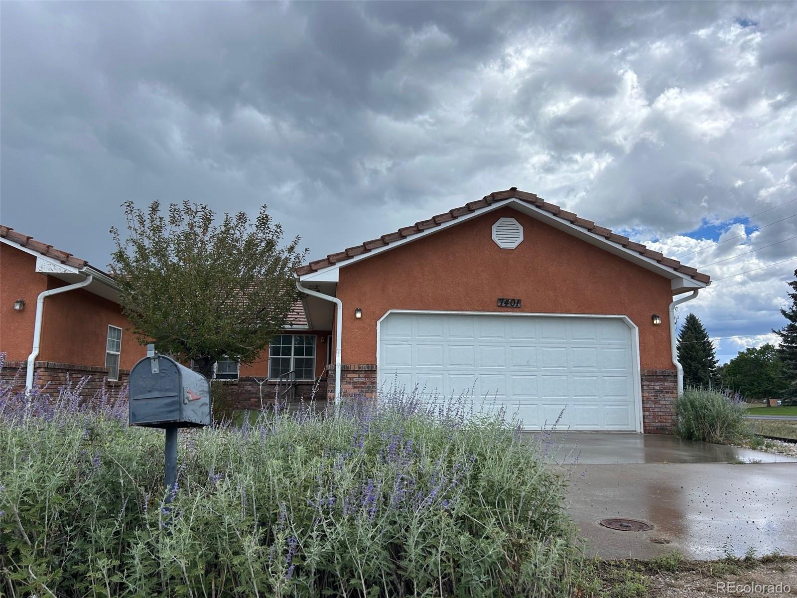7401 County Road 141 Salida, CO 81201 - Photo 2 of 45 a front view of a house with a yard and garage