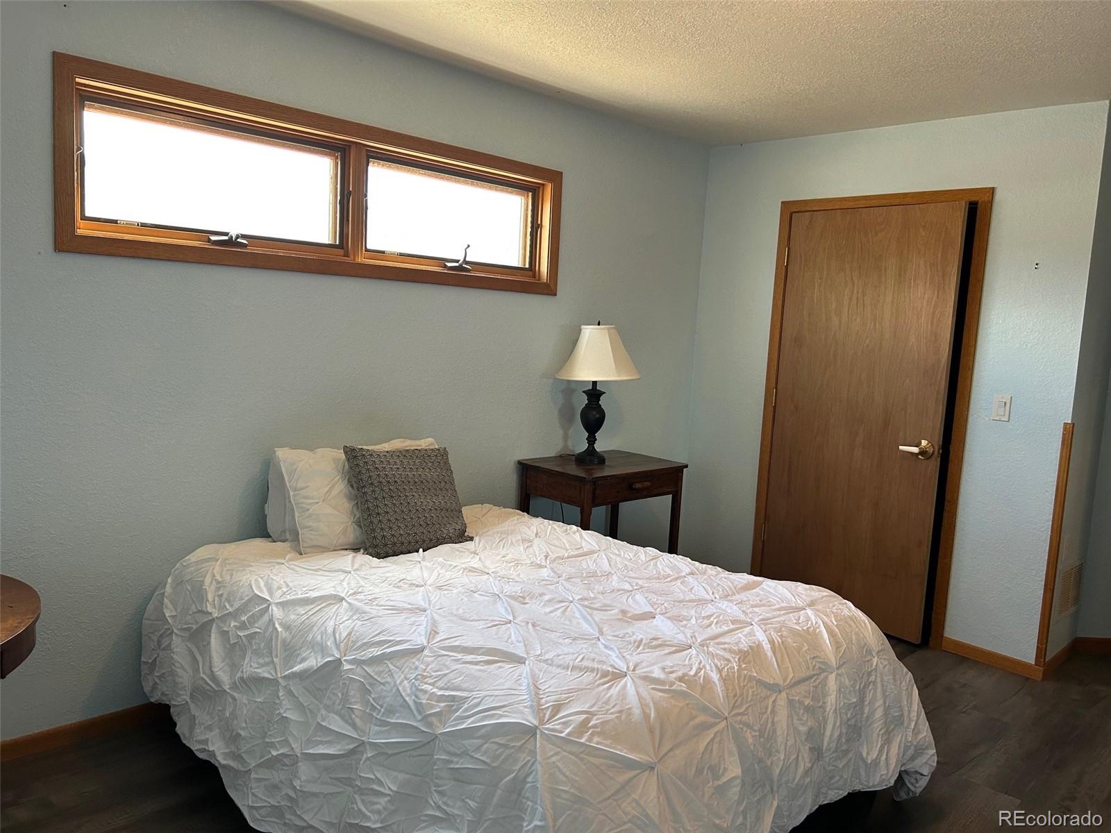 7401 County Road 141 Salida, CO 81201 - Photo 22 of 45 a bedroom with a bed and a window