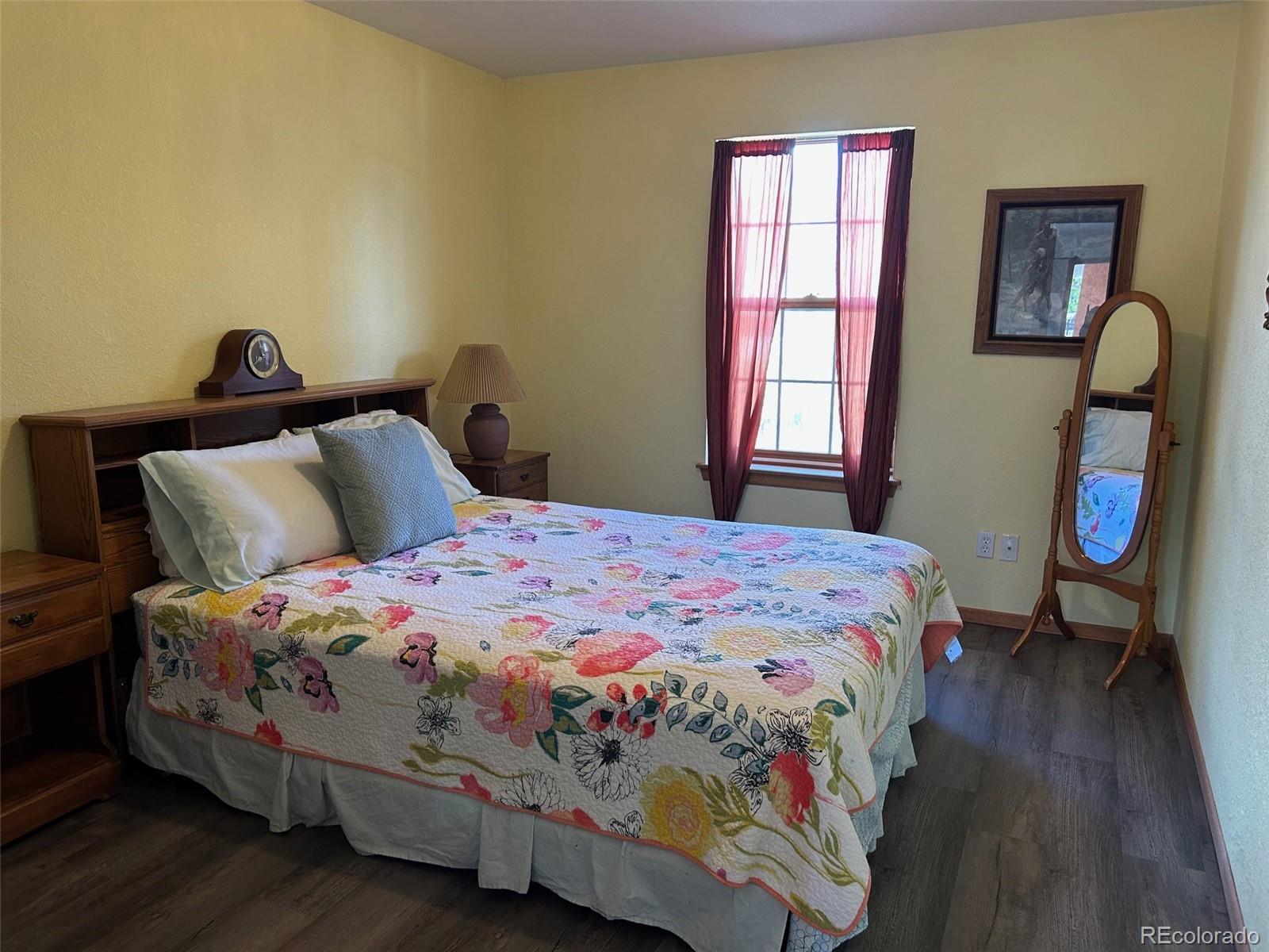 7401 County Road 141 Salida, CO 81201 - Photo 28 of 45 a bedroom with a bed and wooden floor
