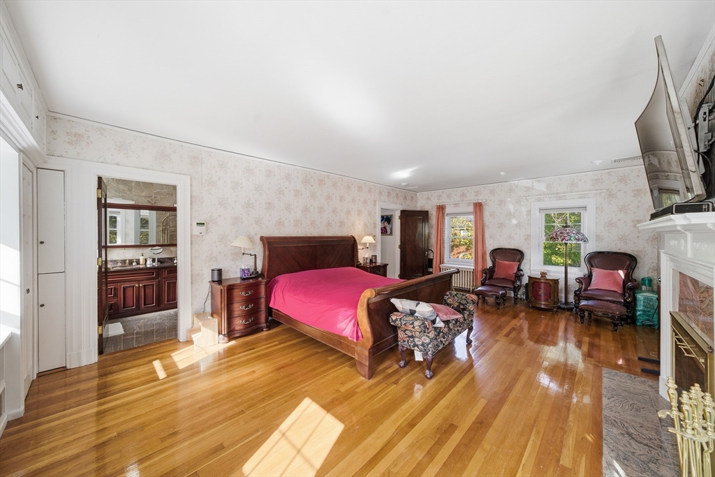 6 Elba Street Brookline, MA 02446 - Photo 17 of 34 a living room with furniture a flat screen tv and a fireplace