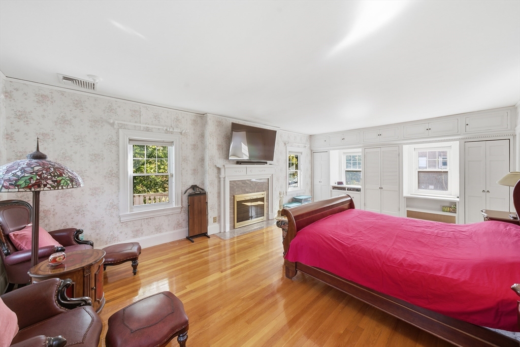 6 Elba Street Brookline, MA 02446 - Photo 19 of 34 a bedroom with a bed a flat screen tv and dresser