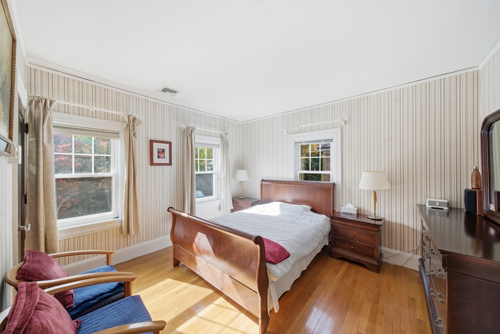 6 Elba Street Brookline, MA 02446 - Photo 22 of 34 a bedroom with a bed and wooden floor