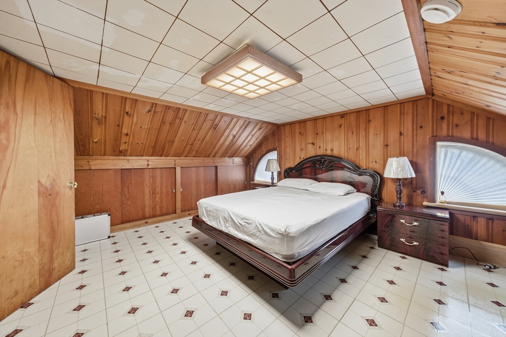 6 Elba Street Brookline, MA 02446 - Photo 24 of 34 a bedroom with a bed and a table