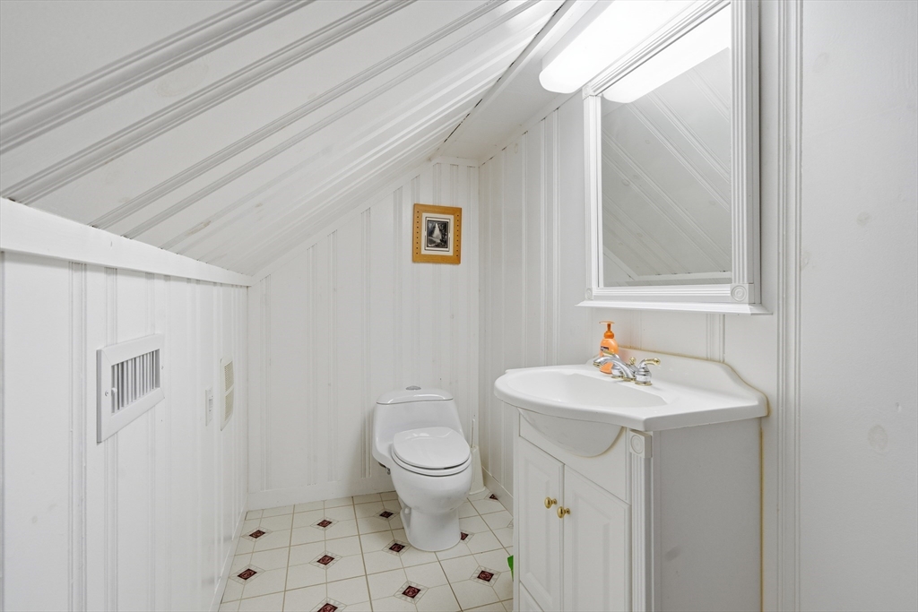 6 Elba Street Brookline, MA 02446 - Photo 26 of 34 a bathroom with a sink toilet and a mirror