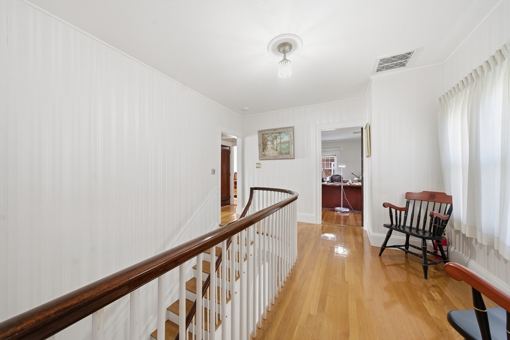 6 Elba Street Brookline, MA 02446 - Photo 27 of 34 a view of a hallway with wooden floor and stairs