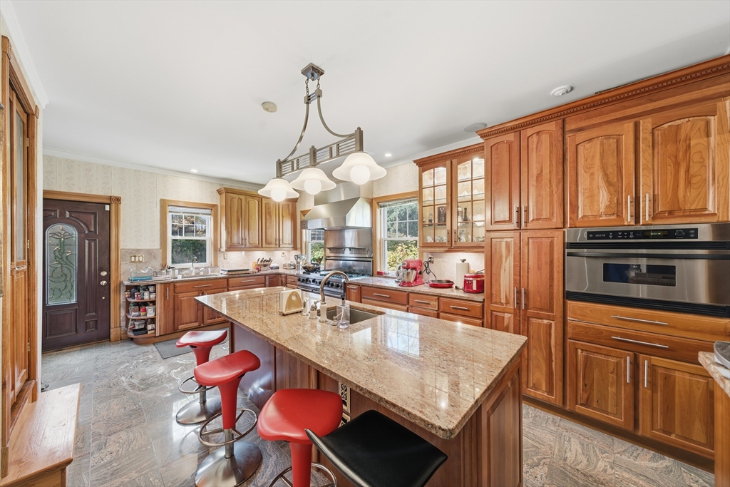6 Elba Street Brookline, MA 02446 - Photo 9 of 34 a kitchen with stainless steel appliances granite countertop a sink stove and refrigerator