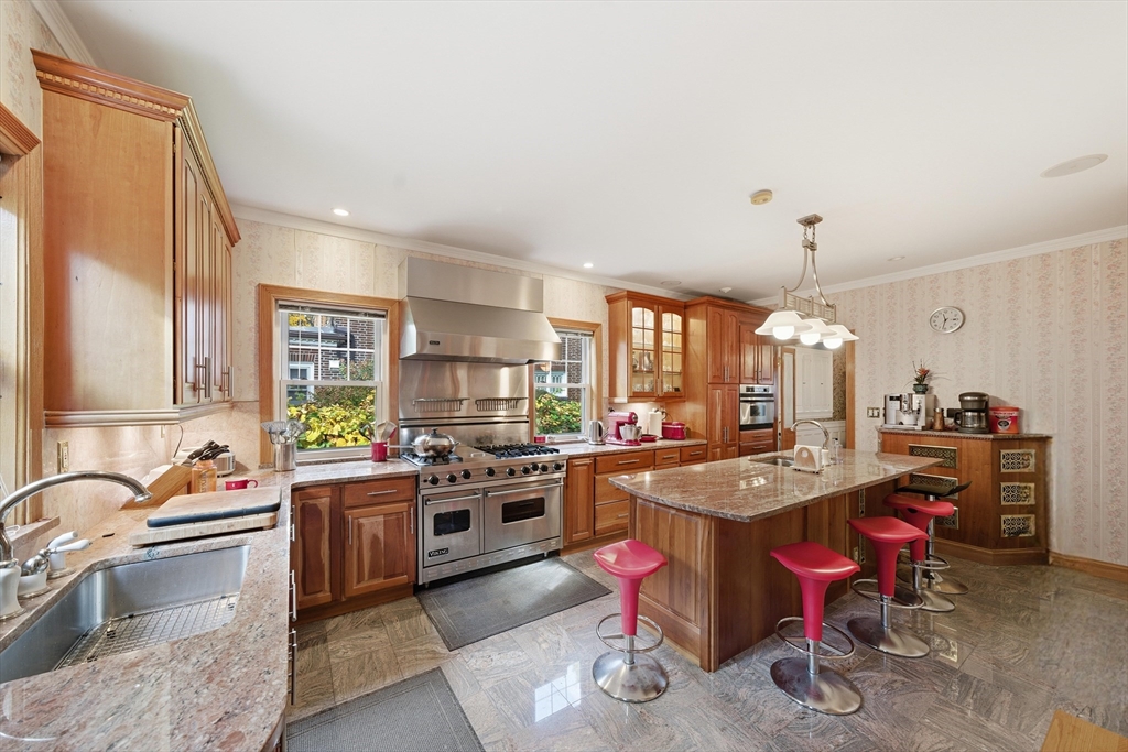 6 Elba Street Brookline, MA 02446 - Photo 10 of 34 a kitchen with stainless steel appliances granite countertop a sink stove and refrigerator