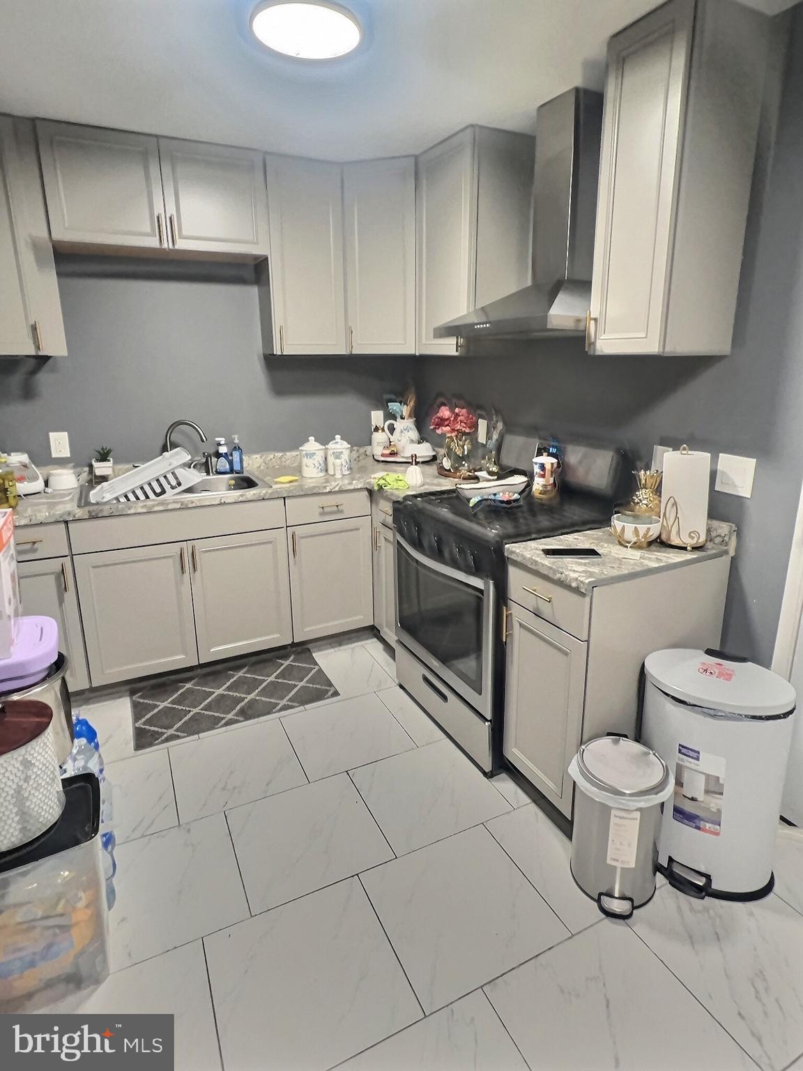 725 Pear Street Reading, PA 19601 - Photo 7 of 12 a kitchen with a stove sink and cabinets