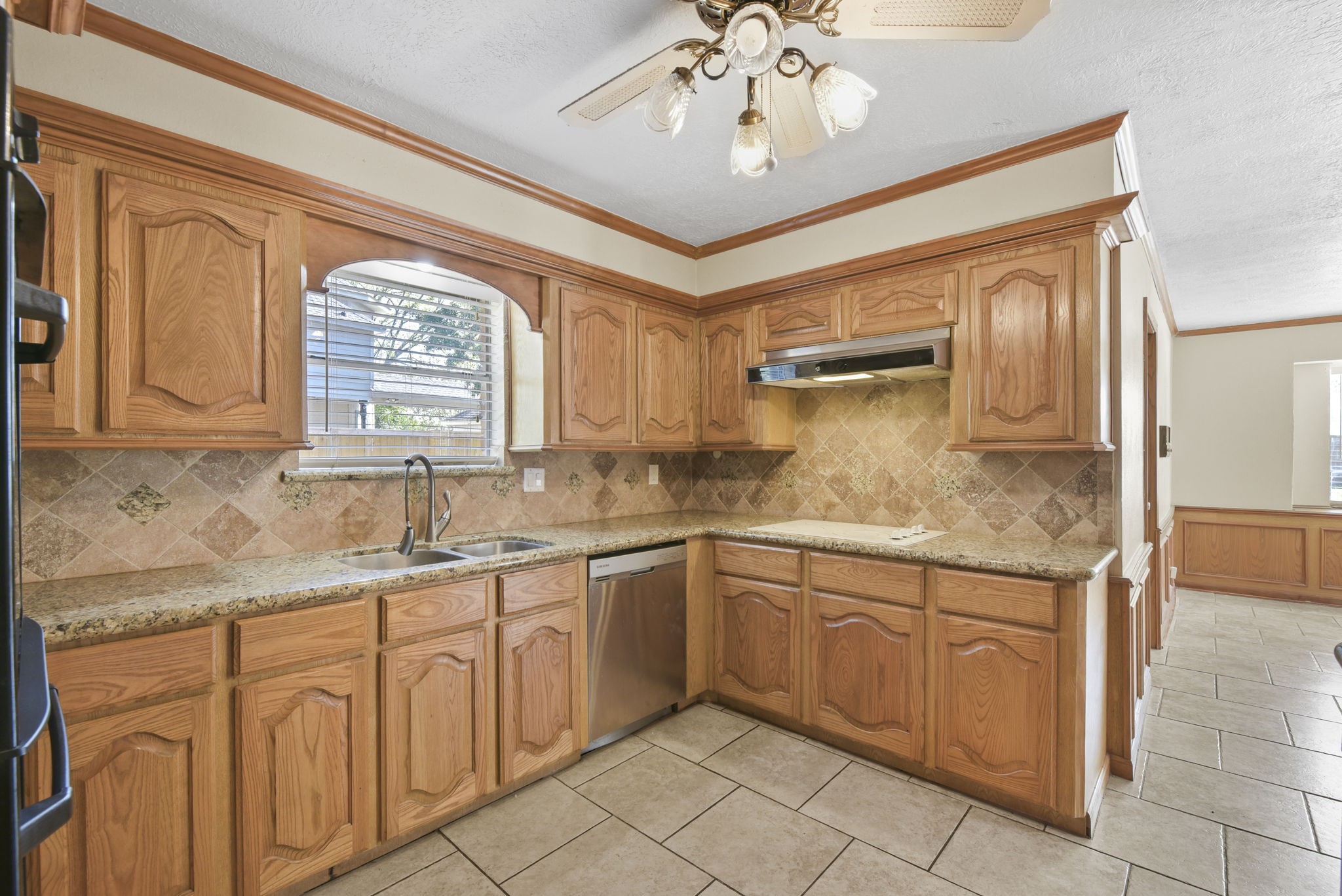 6507 Spring Leaf Drive Spring, TX 77379 - Photo 16 of 34 a kitchen with sink cabinets and chandelier